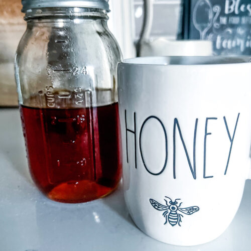 raw honey natural cough syrup recipe remedy next to a white mug that says Honey