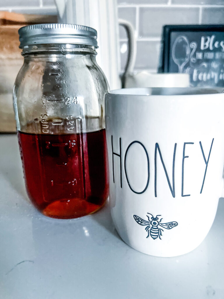 raw honey natural cough syrup recipe remedy next to a white mug that says Honey