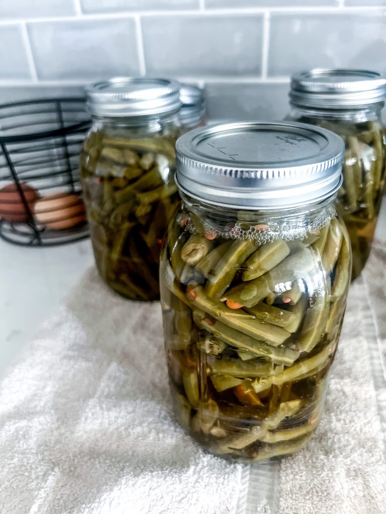 several glass mason jars of home canned green beans